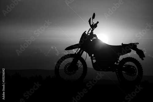Silhouette of a motocross motorcycle of an adventurous tourist in the evening.