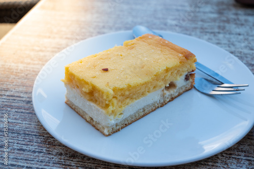 Eierschecke cake on a white plate with a fork