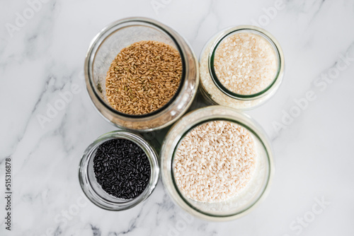 pantry jars with different types of rice including black brown arborio and sushi rice, simple staple ingredients