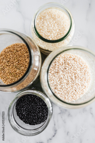 pantry jars with different types of rice including black brown arborio and sushi rice, simple staple ingredients
