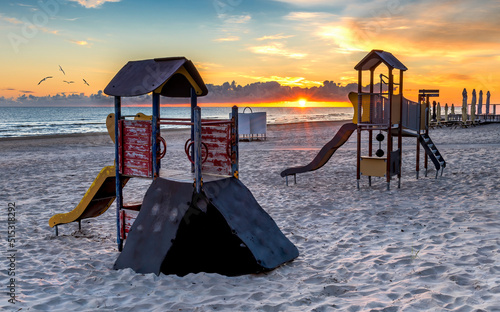 Playground of children on the sandy shore of the Baltic Sea at dawn