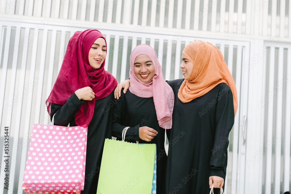 Happy Muslim women walking in the city center - Arabian young girls having fun spending time and laughing together outdoor - concept of lifestyle people culture and religion Happy Muslim women walking in the city center - Arabian young girls having fun spending time and laughing together outdoor - concept of lifestyle people culture and religion
