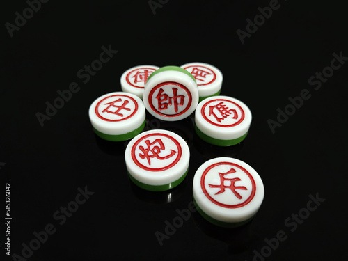 There are Chinese chess scattered on a black background, the content of which is the main generals of the red side  King, Guards, Minister, Chariots, Cannons, Knights and Pawns.