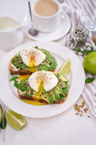 Freshly made poached egg and Avocado toasts on light grey background