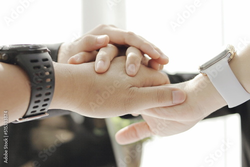 business women meeting and having papers on the table, meeting and shaking hands together, work success