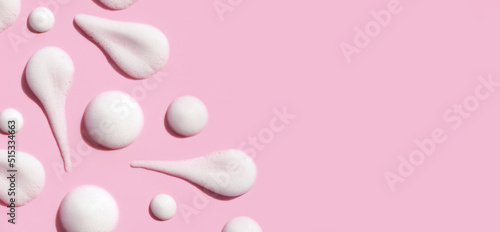 texture foam mousse foam cosmetic smear sample on pink background photo