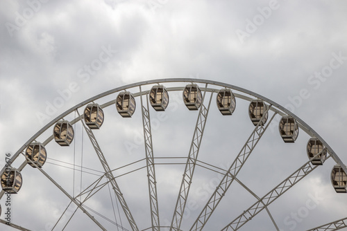 Big wheel with a cloudy sky background.