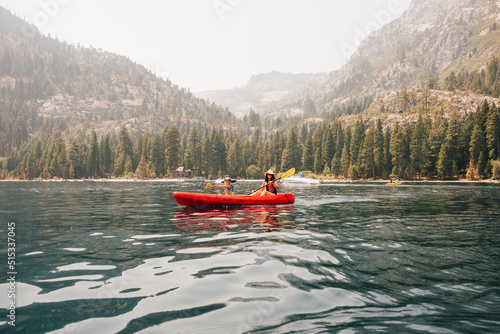 Woman with daughter in kayak at lake photo