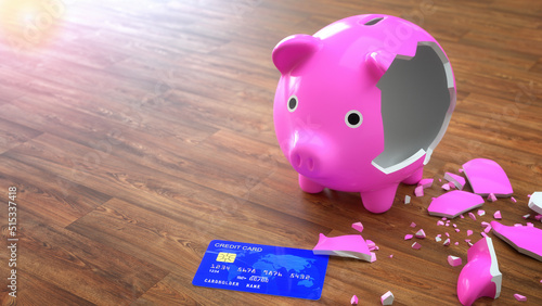 Broken piggy bank and blue color credit card on wooden floor. Credit card debt or  payment strategy concept.