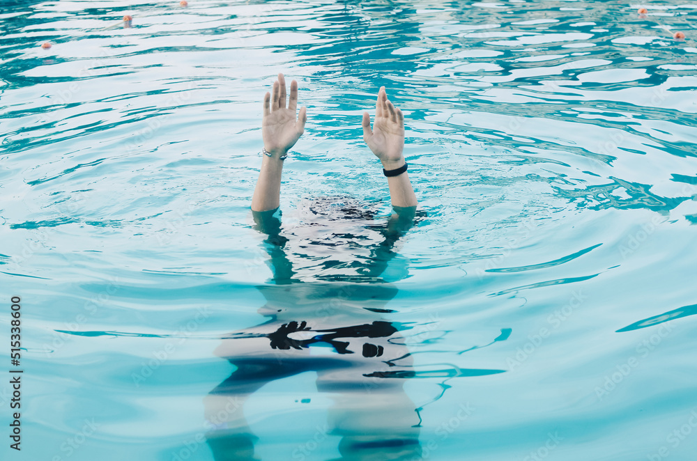 Hands in the pool asking for help. The concept of failure and rescue.