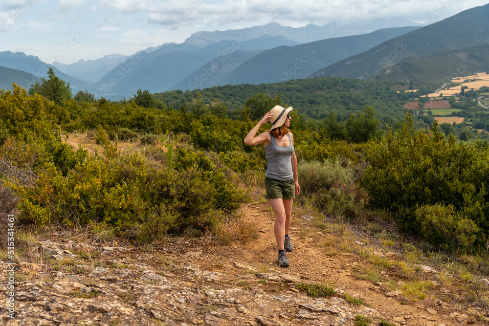 A woman on a trek between the villages of Las Latas to Larrede near Sabiñanigo, Pyrenees aragon