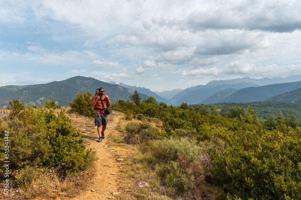 A man on a trek between the villages of Las Latas to Larrede near Sabiñanigo, Pyrenees aragon