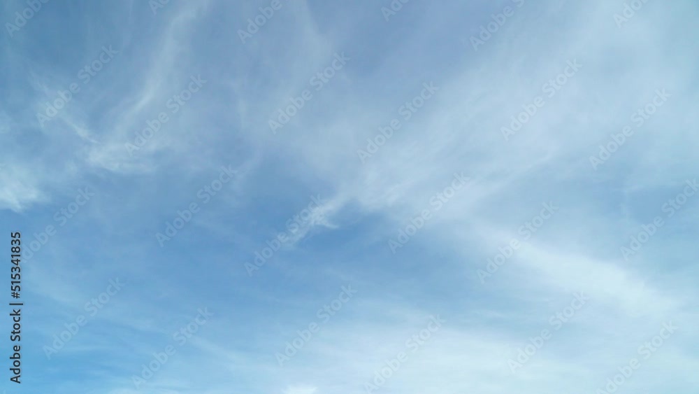 Light white clouds fly across a bright blue sky. Clear sky at sunny summer afternoon. Sky Time lapse, Blue sky with clouds Light white clouds fly across a bright blue sky. Clear sky at sunny summer afternoon. Sky Time lapse, Blue sky with clouds