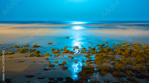 Beautiful seascape with a reflection of moon lights by night in Imesouane Morocco