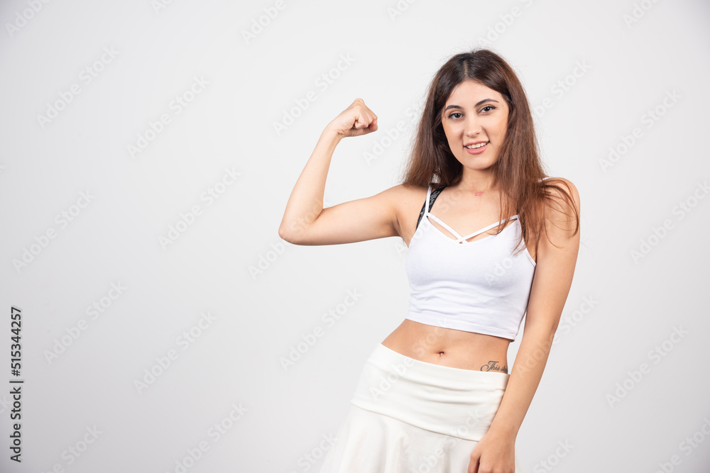 Young woman showing her arm for feminine and independent strength