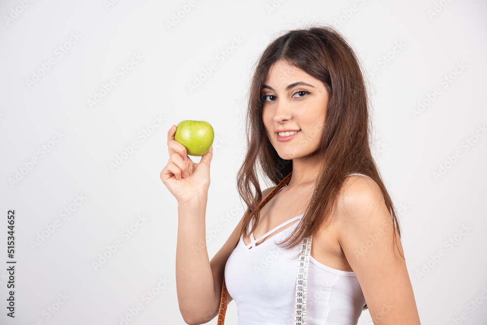 Portrait of smiling woman with a green apple Portrait of smiling woman with a green apple
