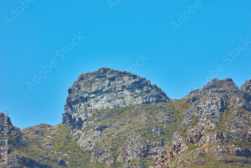 Scenic landscape of Twelve Apostles mountain under clear blue sky copy space in Cape Town, South Africa. Famous travel and tourism destination with steep hiking terrain and growing trees and bushes