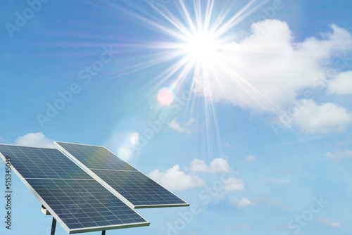 Polycrystalline silicon solar cells panels isolated on blue sky with sun light effect background. Alternative renewable energy from the sun.