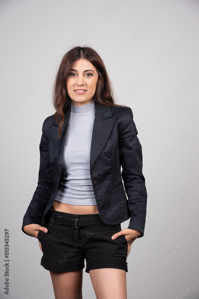 Portrait of beautiful young woman standing and looking at camera Portrait of beautiful young woman standing and looking at camera