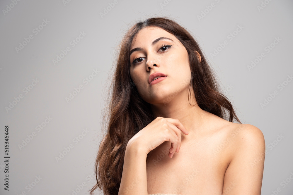 Portrait of beautiful young woman standing and looking at camera Portrait of beautiful young woman standing and looking at camera