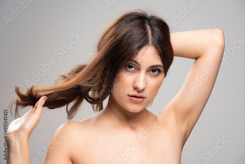 Portrait of beautiful young woman standing and looking at camera