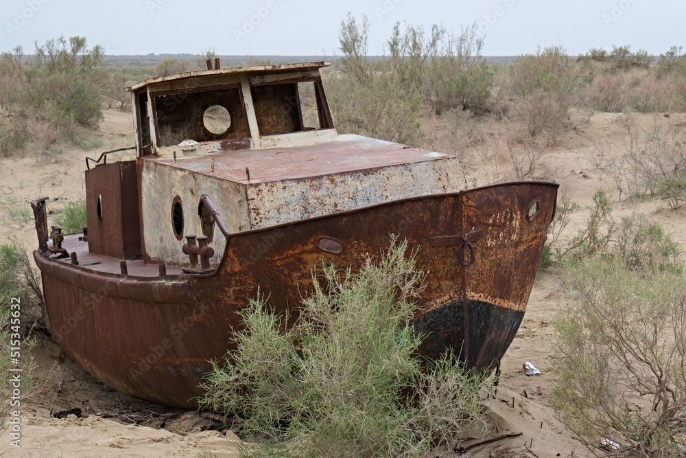 Wrecks of abandoned ships on the dry bottom of the Aral Lake near Moynaq city. Karakalpakstan, Uzbekistan.