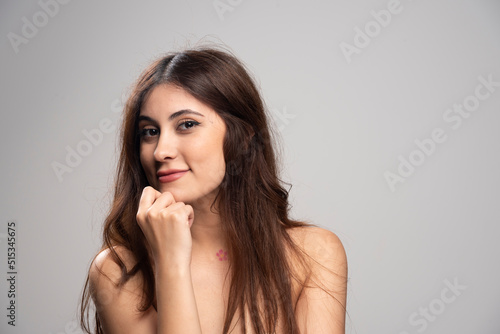 Portrait of beautiful young woman standing and looking at camera