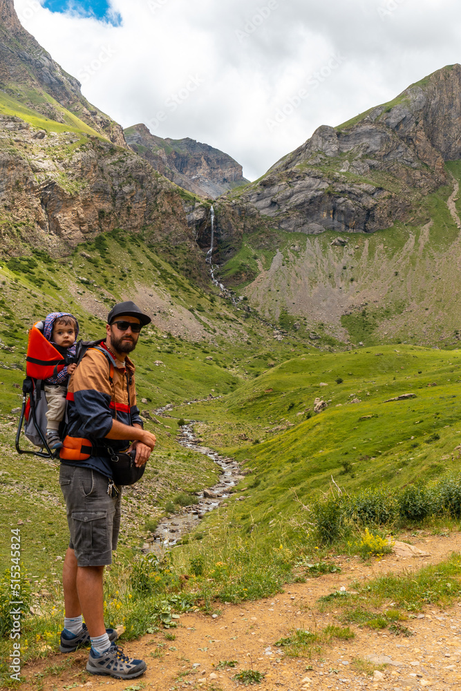A young man next to the Salto de Tendenera Waterfall in the Ripera Valley, Panticosa, Pyrenees A young man next to the Salto de Tendenera Waterfall in the Ripera Valley, Panticosa, Pyrenees