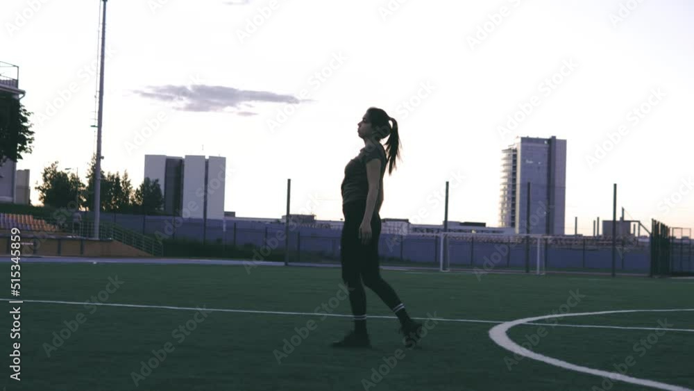 Close up beautiful Caucasian female in sporty clothes practicing wheel gymnastic exercise at the stadium. Yoga concept. Female gymnast at stadium practicing, doing fitness