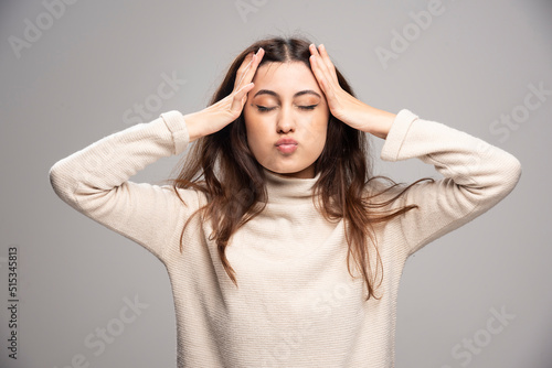 Portrait of a young woman posing and holding hair © azerbaijan-stockers