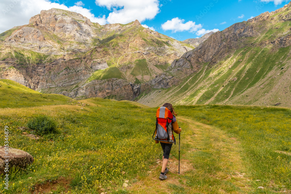 A young woman on mountain trekking with her son in the Ripera valley, Pyrenees mountains