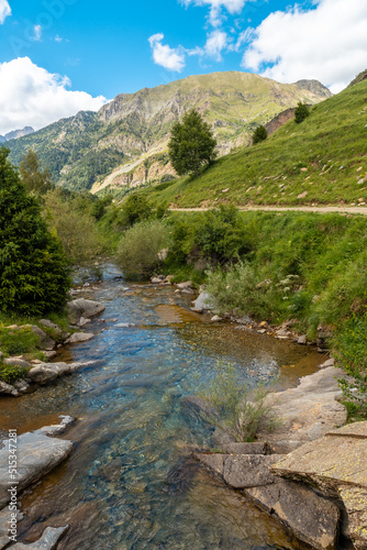 Mountain path along the river in the Ripera valley in summer, Pyrenees Mountains in summer © unai