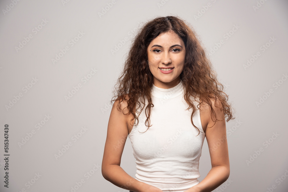Young woman in white blouse standing over a white wall Young woman in white blouse standing over a white wall