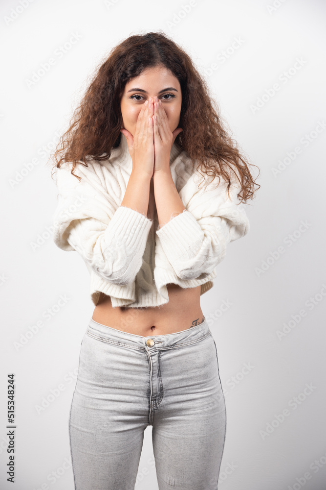 Young woman in white sweater with curly hair posing Young woman in white sweater with curly hair posing