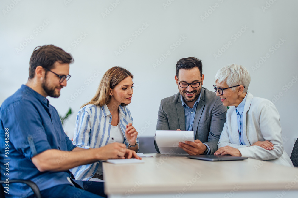 Close up of a people working together, having a meeting, reading some new company rules. Close up of a people working together, having a meeting, reading some new company rules.