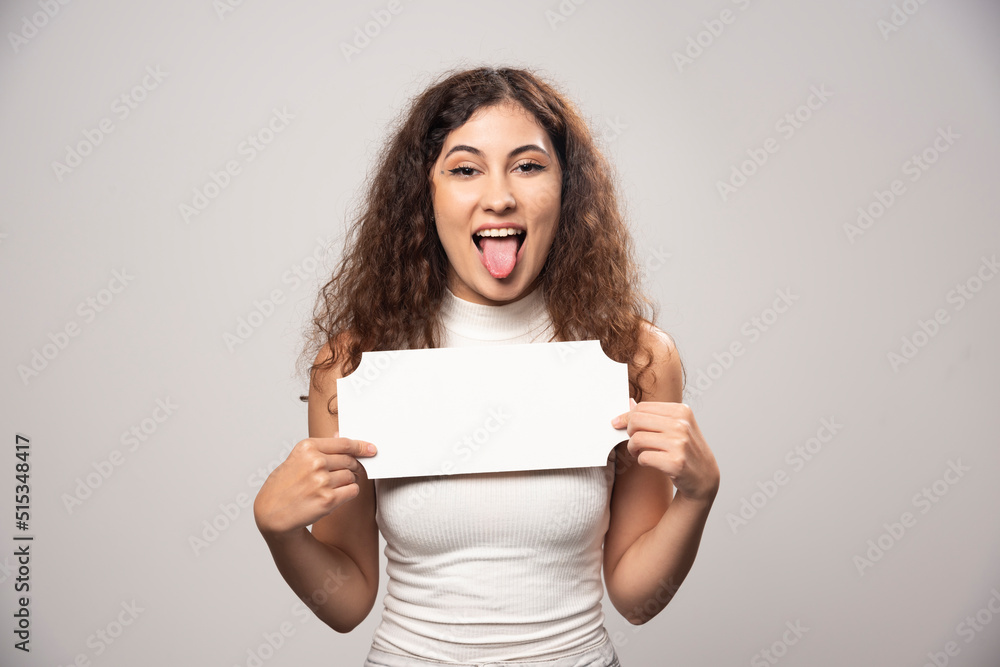 Young woman holding empty blank white speech poster Young woman holding empty blank white speech poster
