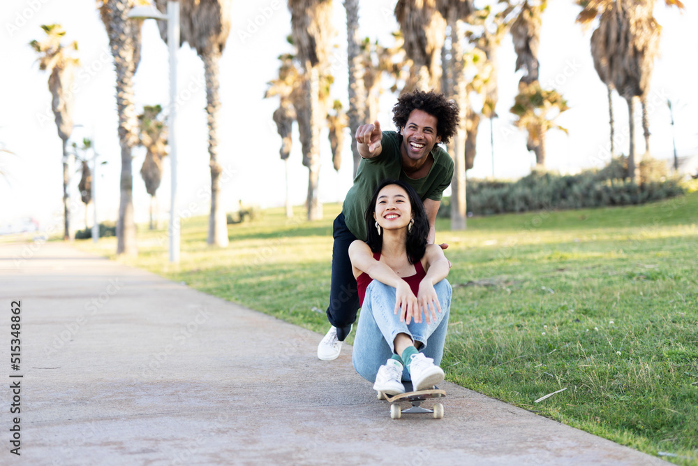 Boyfriend and girlfriend with skateboard. Happy couple enjoy in sunny day. Boyfriend and girlfriend with skateboard. Happy couple enjoy in sunny day.