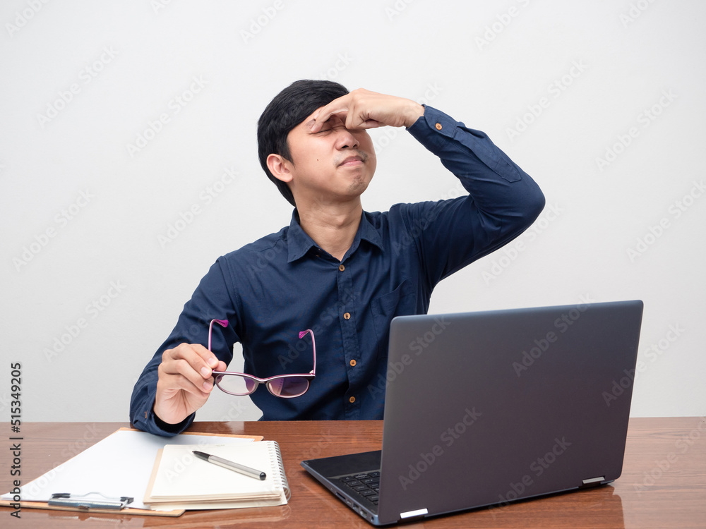 Man tried from working take off glasses feels eyestrain and headache Man tried from working take off glasses feels eyestrain and headache