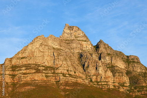 Landscape view of Table Mountain in Cape Town, South Africa against blue sky with copy space. Travel and tourism of famous landmark, rocky and rough terrain. Holiday and vacation abroad and overseas