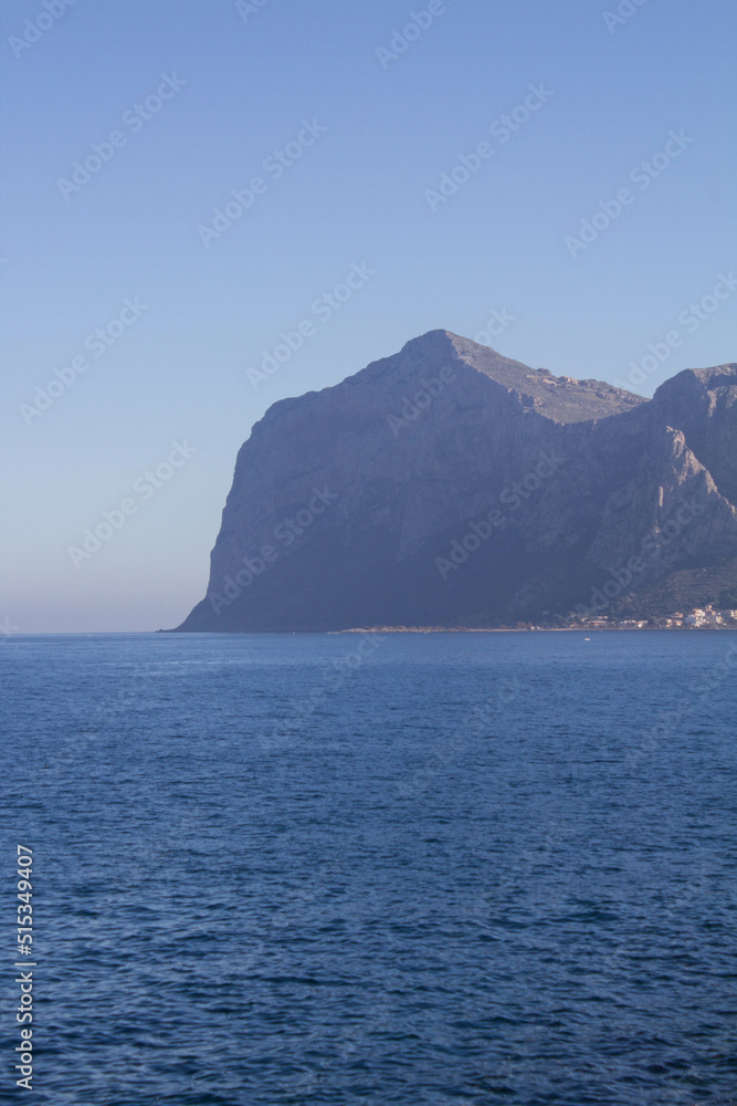 evocative image of sea coast with promontory on the background in Sicily, Italy