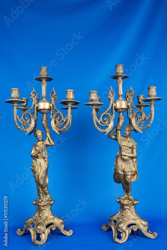 two classic bronze chandeliers with figures of women, ancient candlesticks studio photo, antique bronze candlesticks isolated, brass candelabra, vintage gold сandlesticks photo