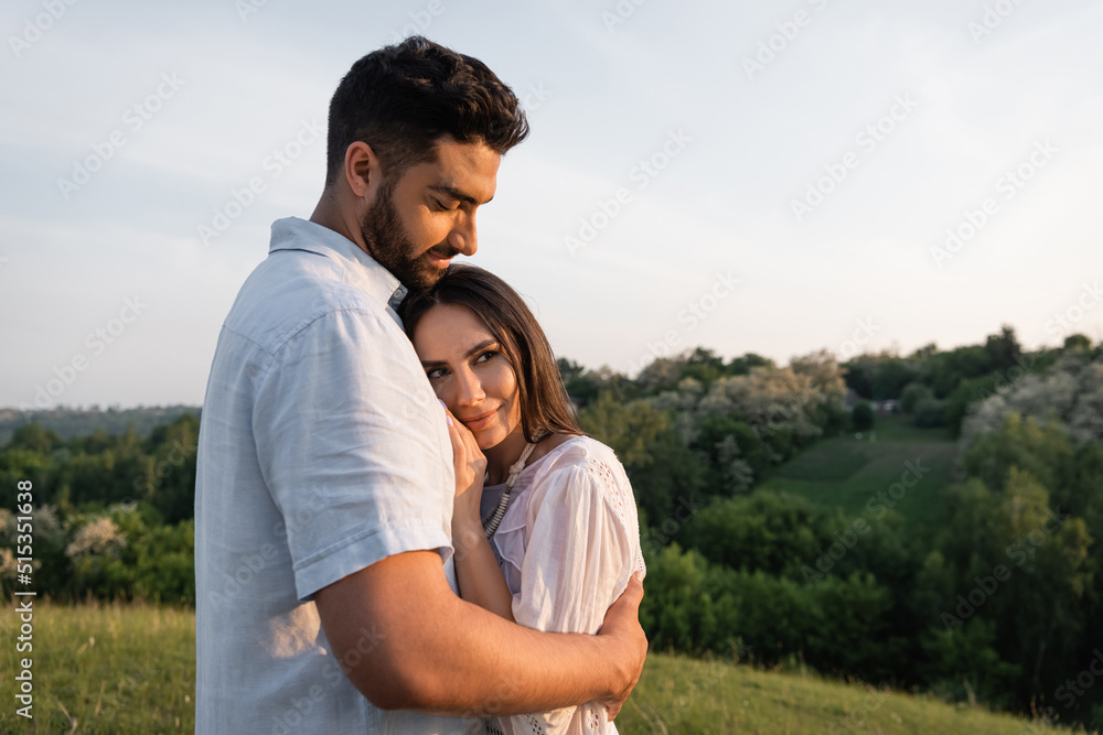 happy couple embracing in countryside in summer. happy couple embracing in countryside in summer.