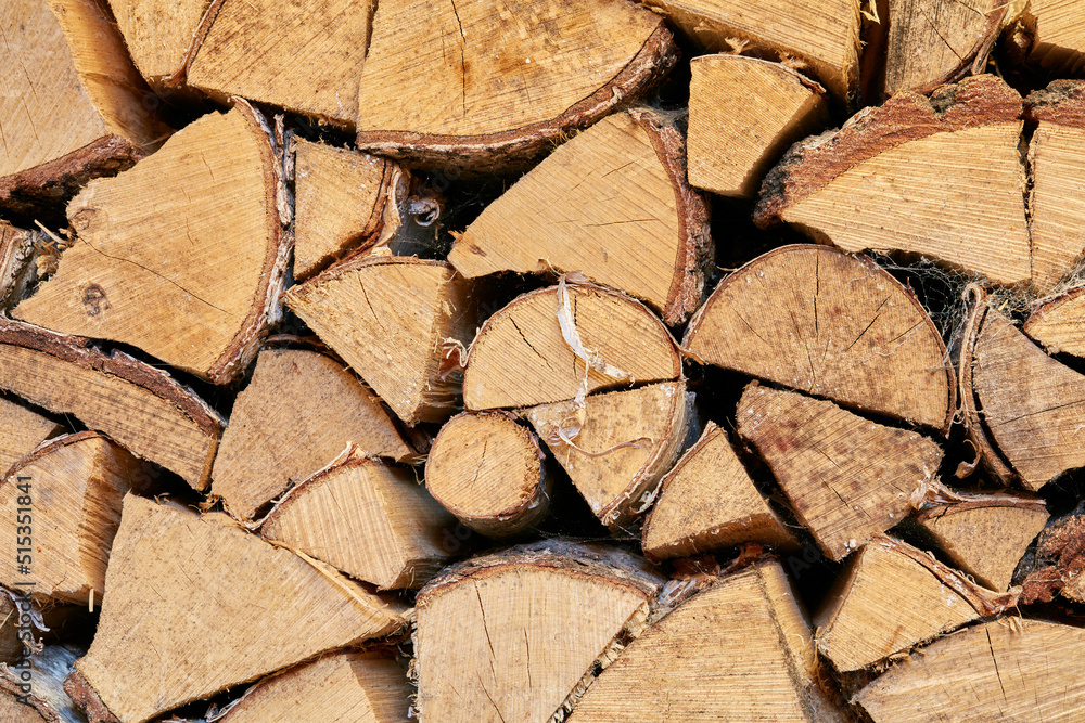 Above view of chopped firewood, logs stacked together in storage pile. Closeup of wooden background and texture. Collecting dry rustic wood as a source of energy. Lumber split hardwood with copyspace Above view of chopped firewood, logs stacked together in storage pile. Closeup of wooden background and texture. Collecting dry rustic wood as a source of energy. Lumber split hardwood with copyspace