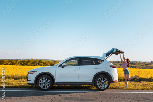 woman closing car trunk parked at roadside