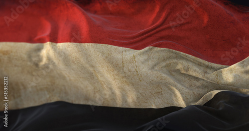 Old Yemen Flag waving at wind photo