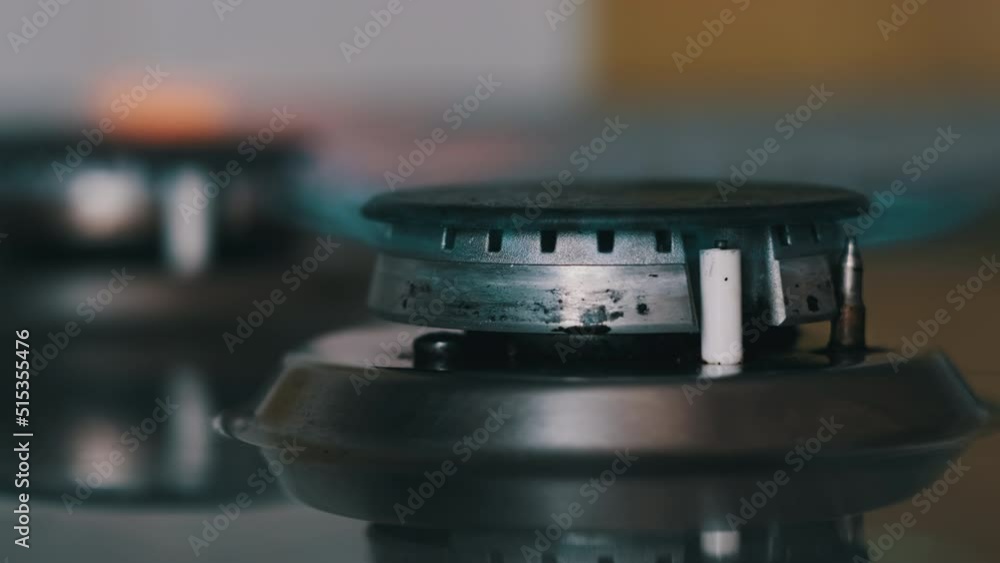 Fire in the gas burner is lit in slowmo. The flame of an electric