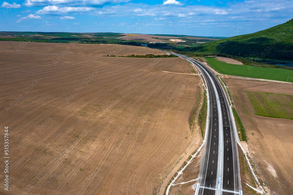 Aerial view from a drone of a new highway. Transportation and infrastructure concept Aerial view from a drone of a new highway. Transportation and infrastructure concept