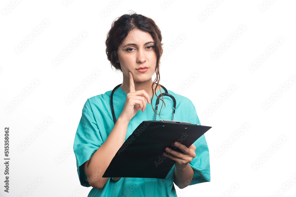 Female doctor holding black clipboard in hands on white background Female doctor holding black clipboard in hands on white background