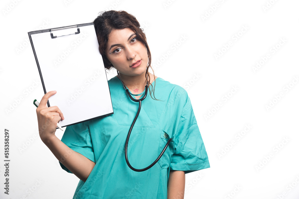 Female doctor showing empty clipboard with pen and stethoscope on white background Female doctor showing empty clipboard with pen and stethoscope on white background