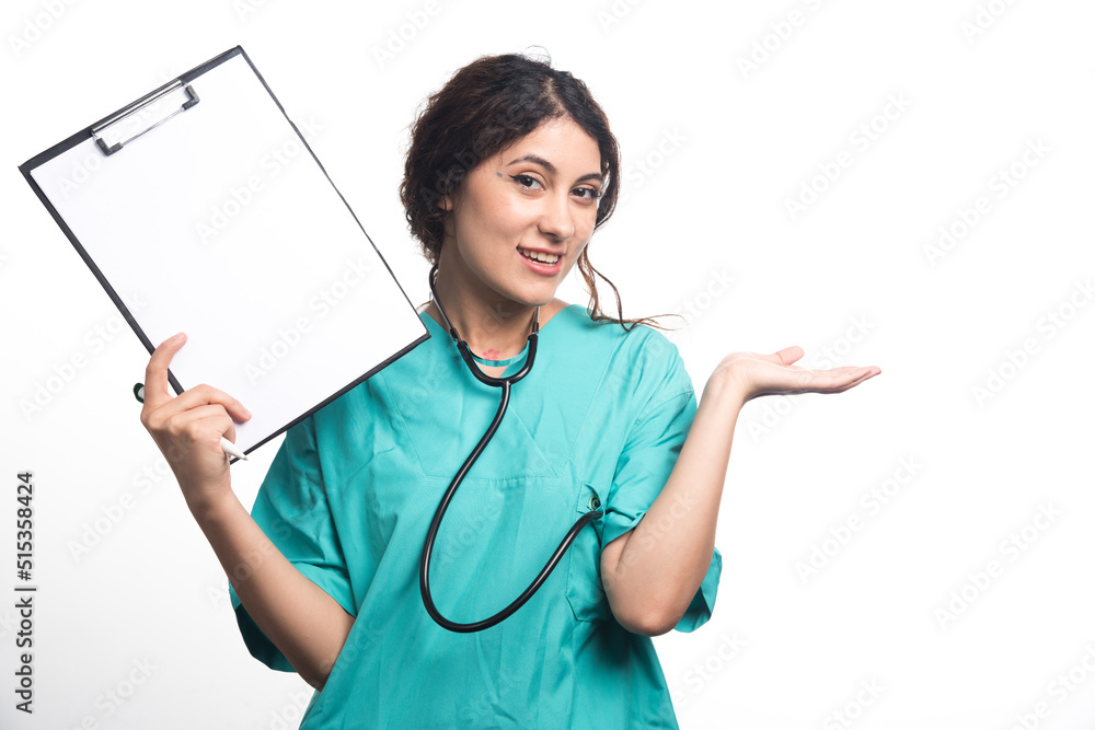 Female doctor showing empty clipboard with pen and stethoscope on white background Female doctor showing empty clipboard with pen and stethoscope on white background